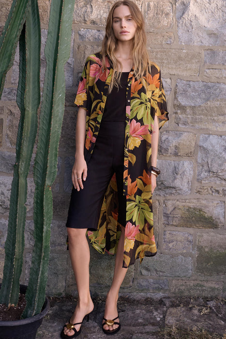 Woman wearing Joseph Ribkoff tropical print chiffon blouse for resort vacation outfit