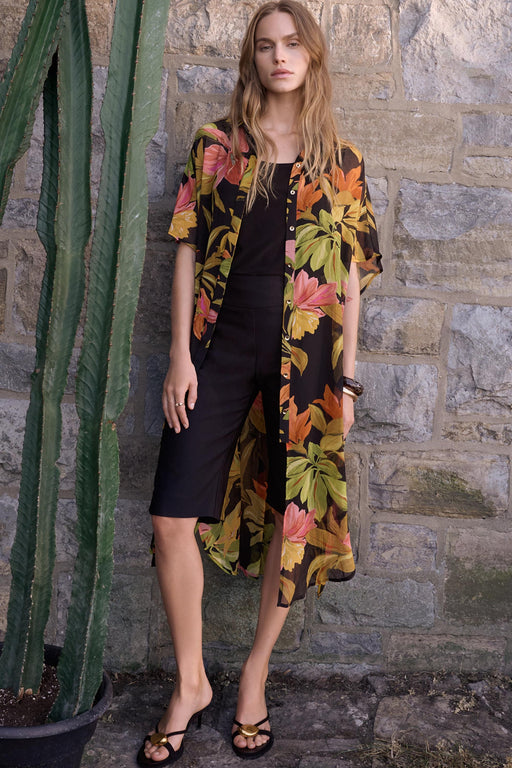 Woman wearing Joseph Ribkoff tropical print chiffon blouse for resort vacation outfit