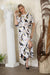 Woman wearing Joseph Ribkoff tropical print trapeze dress for resort vacation outfit