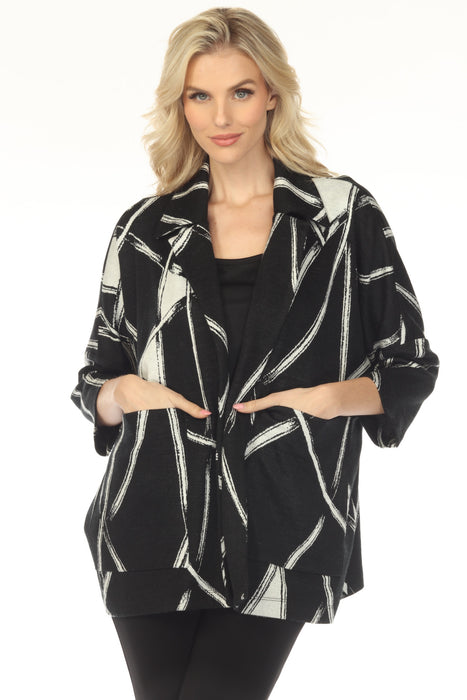 Woman wearing a black and white abstract-patterned jacket with front pockets from Joseph Ribkoff