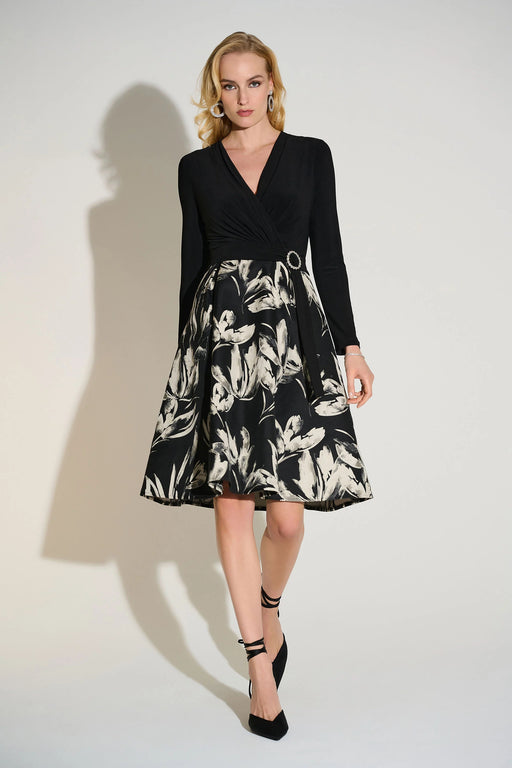 Woman wearing a fit and flare dress with solid wrap top and floral jacquard skirt