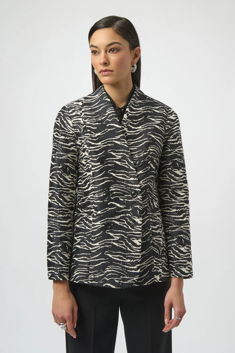 Woman wearing a black and white zebra patterned blazer jacket with double breast buttons