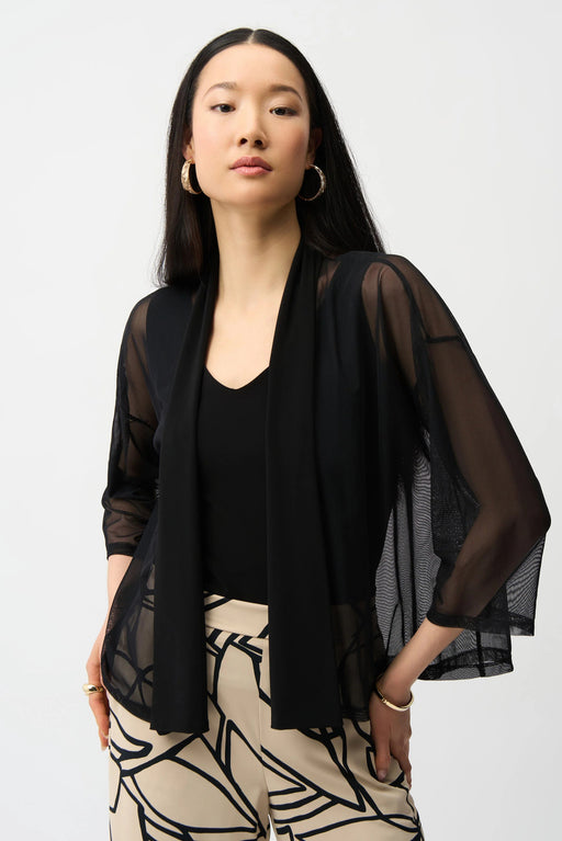 Woman wearing a black sheer jacket with open front and 3/4 sleeves from Joseph Ribkoff
