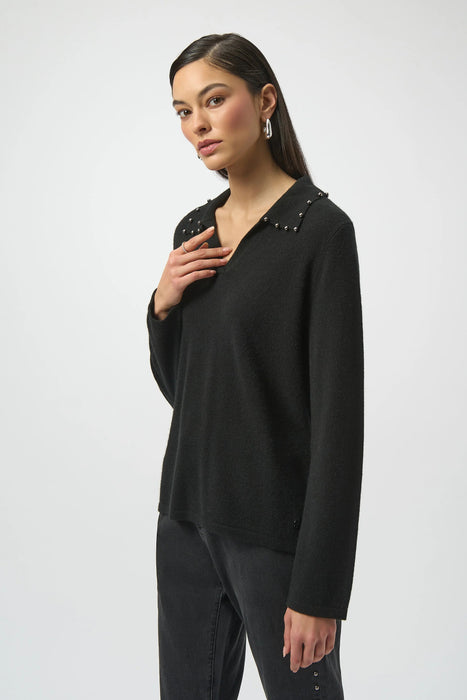 Woman wearing a black cashmere sweater with pearl accent collar and long sleeves from Joseph Ribkoff