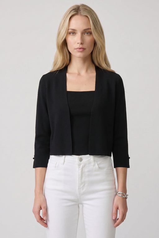 Woman wearing a black open front bolero with pearl ornament on the 3/4 sleeves from Joseph Ribkoff