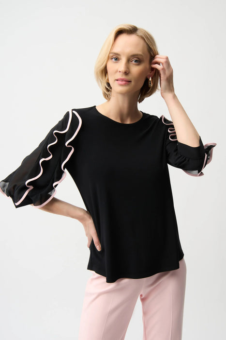 Woman wearing Joseph Ribkoff ruffle sleeve top for elegant office outfit
