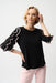 Woman wearing Joseph Ribkoff ruffle sleeve top for elegant office outfit
