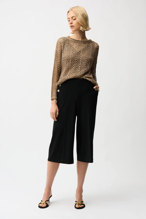 Woman wearing a black cropped wide leg pants with pull on elastic waist and side pockets from Joseph Ribkoff