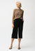Woman wearing a black cropped wide leg pants with pull on elastic waist and side pockets from Joseph Ribkoff