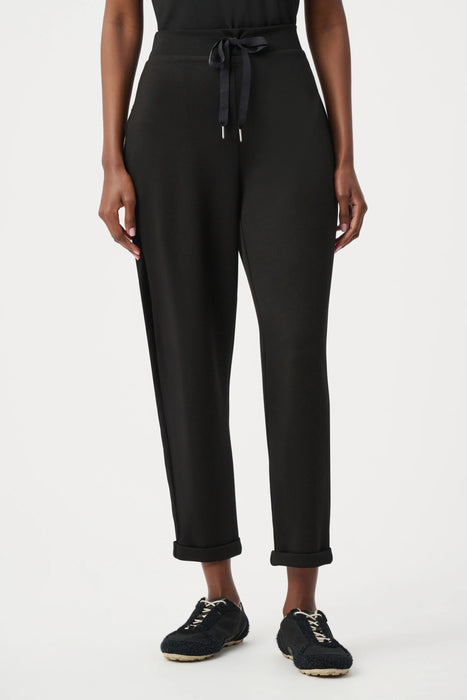 Woman wearing Joseph Ribkoff drawstring jogger pants for chic travel outfit