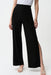 Woman wearing a black wide leg pull on pants with knee-length side slit from Joseph Ribkoff