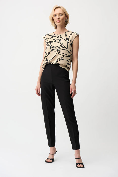 Woman wearing a black pull on slim ankle-length pants from Joseph Ribkoff