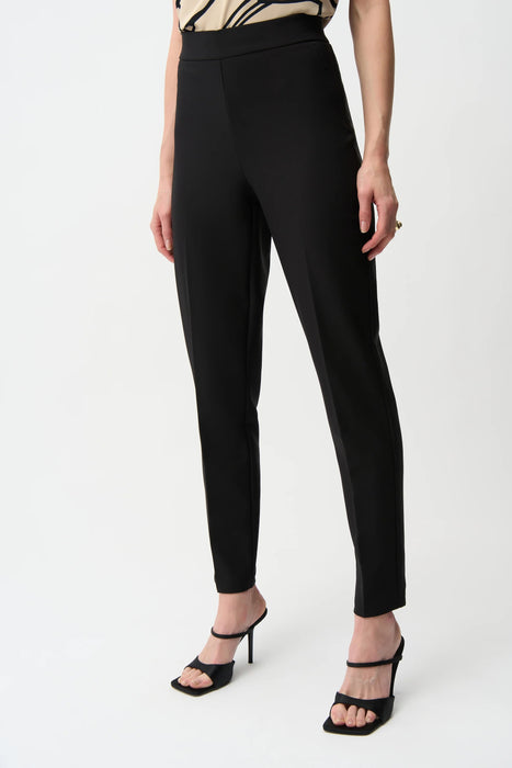 Woman wearing a black pull on slim ankle-length pants from Joseph Ribkoff