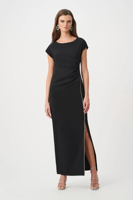 Woman wearing a black long evening dress with ruching at the waist and rhinestone-trimmed side slit from Joseph Ribkoff