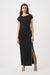 Woman wearing a black long evening dress with ruching at the waist and rhinestone-trimmed side slit from Joseph Ribkoff