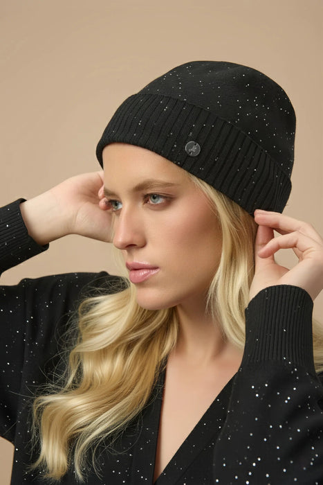 Woman wearing black sequined knitted beanie from Joseph Ribkoff