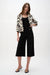 Woman wearing a black Joseph Ribkoff silky knit culotte pants for elegant office outfit