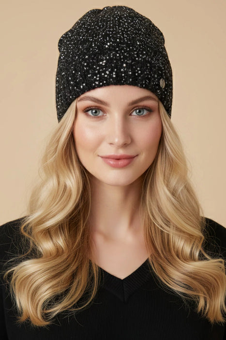 Woman wearing a black knitted beanie with silver sequins from Joseph Ribkoff