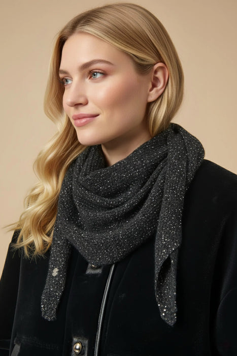 Woman wearing a black knitted scarf with silver sequins from Joseph Ribkoff