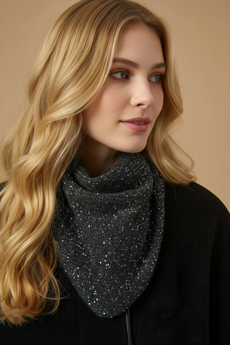Woman wearing a black knitted scarf with silver sequins from Joseph Ribkoff