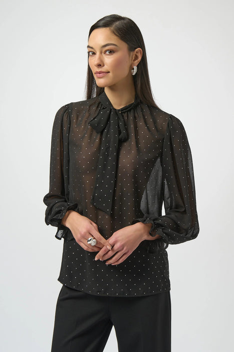 Woman wearing a black sheer chiffon blouse with a pussy bow tie neck