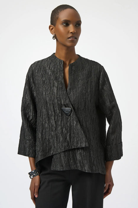 Woman wearing a black textured jacket from Joseph Ribkoff