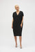 Woman wearing a black gauze midi cocoon dress with v-neck and short sleeves
