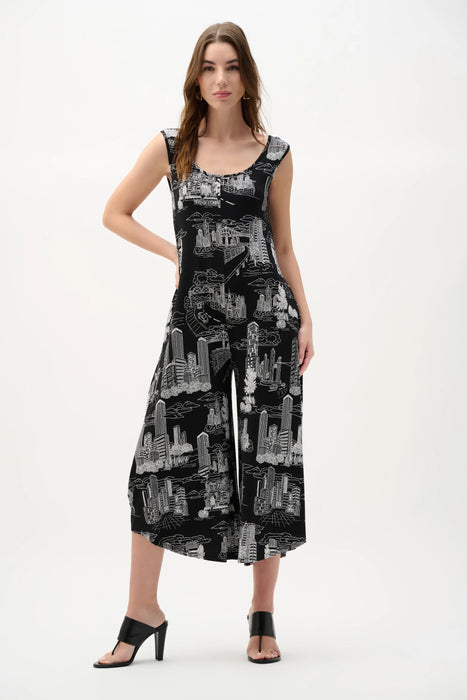 Woman wearing a black and vanilla conversational print culotte jumpsuit with wide-leg silhouette and sleeveless design for a chic modern look