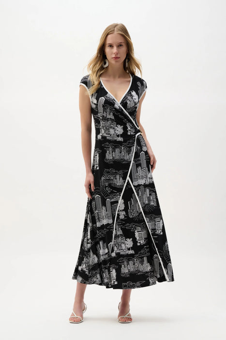 Woman wearing a black and vanilla conversational print fit and flare midi dress with wrap-style bodice and contrast trim, styled for an elegant modern look