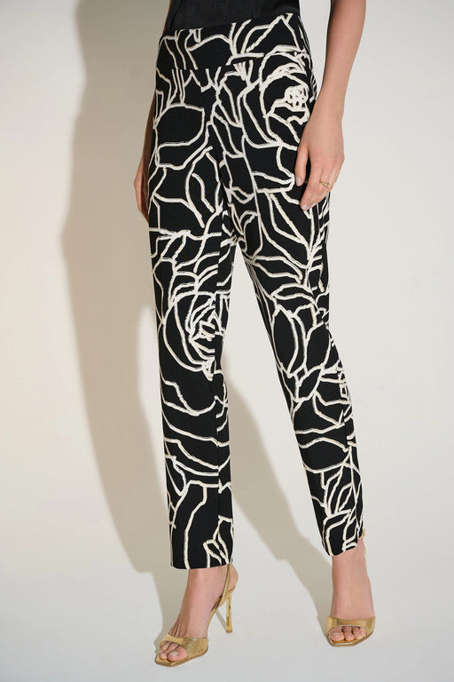 Woman wearing a black and white slim straight pant with abstract floral pattern