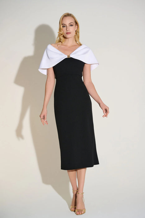 Woman wearing a black midi sheath dress with a white cape collar