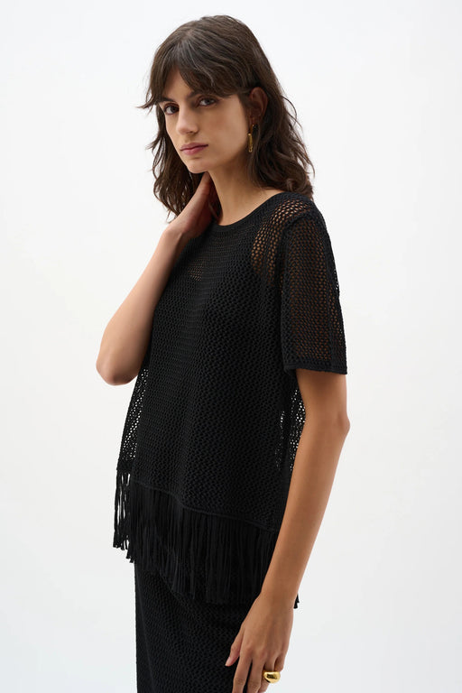 Woman wearing Joseph Ribkoff black viscose fringe sweater knit top styled for casual chic outings, resort wear, summer events, and relaxed evening looks.