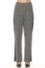 Woman wearing a black and white glen plaid jacquard pant with wide leg and solid side panel from Joseph Ribkoff