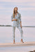 Woman wearing a blue and beige geometric printed straight ankle pants with pull on waistband from Joseph Ribkoff