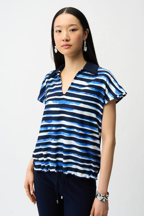Woman wearing Joseph Ribkoff blue and vanilla stripe cocoon top styled for casual chic outings, office wear, travel days, and modern relaxed fashion looks.