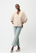 Woman wearing Joseph Ribkoff boxy top with mandarin collar, featuring a relaxed silhouette, soft drape fabric, and elegant minimalist design for modern chic styling.