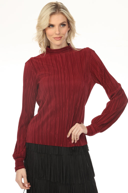 Woman wearing a red micro pleated blouse with mock neck and long sleeves from Joseph Ribkoff