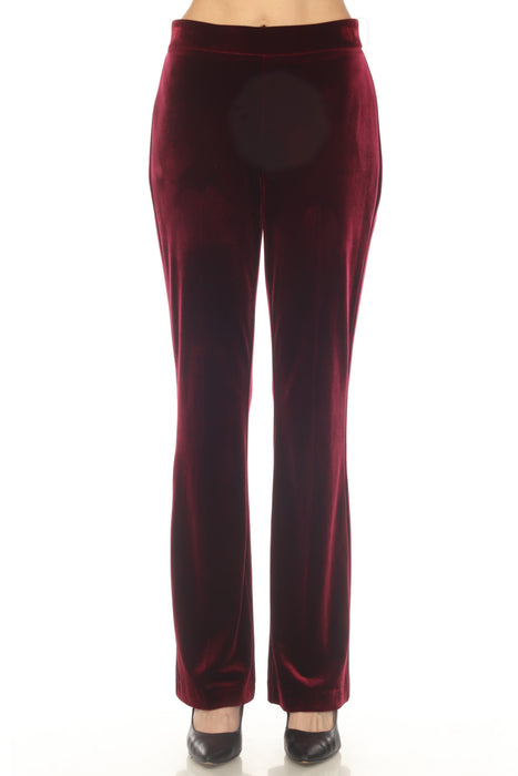 Woman wearing a red velvet pants with pull on elastic waistband and flared leg from Joseph Ribkoff