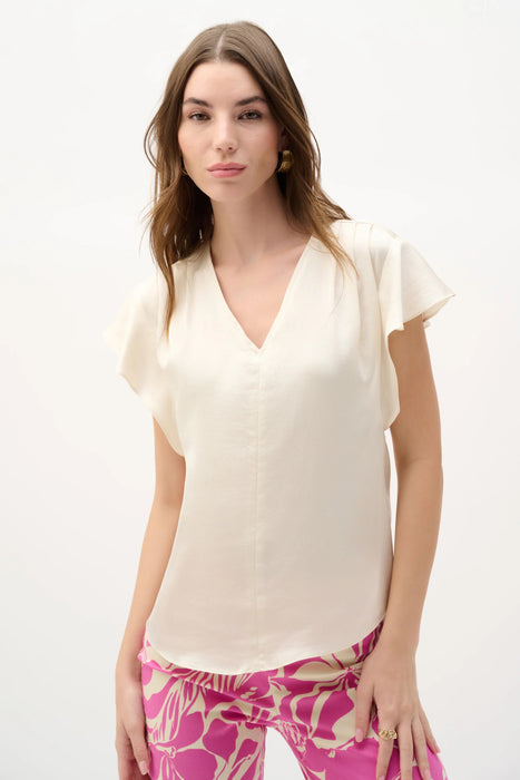 Woman wearing Joseph Ribkoff canvas butterfly sleeves top styled for office chic, brunch, casual outings, and elegant evening occasions.