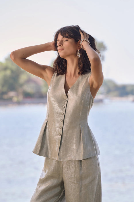 Woman wearing Joseph Ribkoff foiled linen peplum vest styled for summer events, resort wear, coordinated sets, and elegant casual outfits.