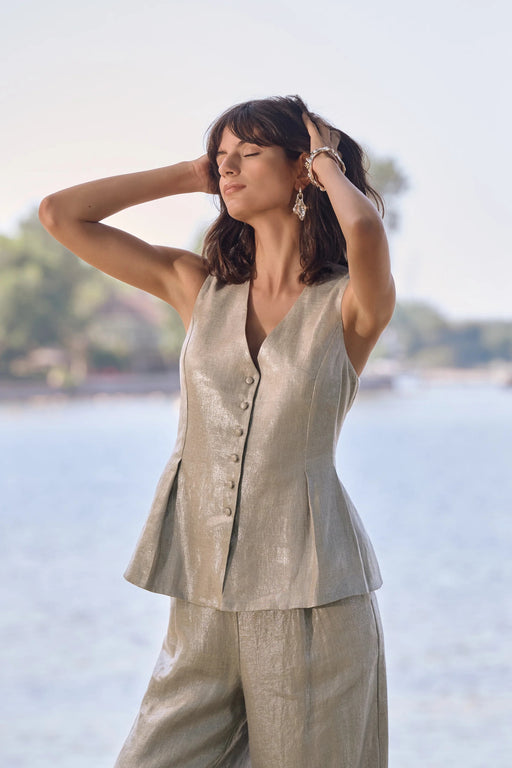 Woman wearing Joseph Ribkoff foiled linen peplum vest styled for summer events, resort wear, coordinated sets, and elegant casual outfits.