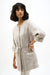 Woman wearing Joseph Ribkoff foiled linen versatile jacket styled for resort wear, office chic, and modern casual layered outfits.