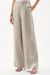 Woman wearing Joseph Ribkoff champagne linen pull-on wide-leg pants styled for resort vacation, summer brunch, vacation travel, and elegant daytime occasions.