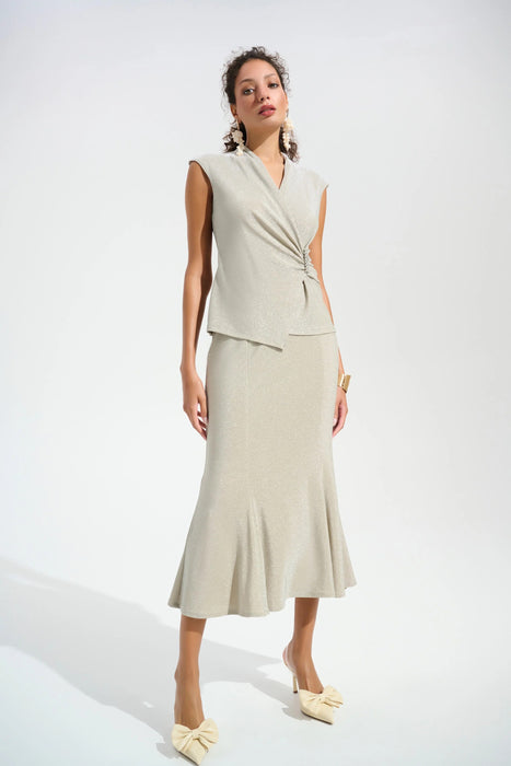 Woman wearing a sparkly beige trumpet skirt with high waist and midi length from Joseph Ribkoff