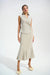 Woman wearing a sparkly beige trumpet skirt with high waist and midi length from Joseph Ribkoff