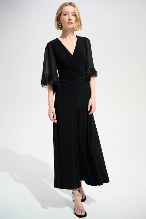 Woman wearing blue chiffon sleeve wide leg jumpsuit with wide leg silhouette and elegant evening style