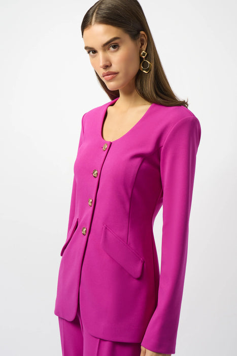 Woman wearing a bright pink fitted jacket with button front closure and decorative flap pockets