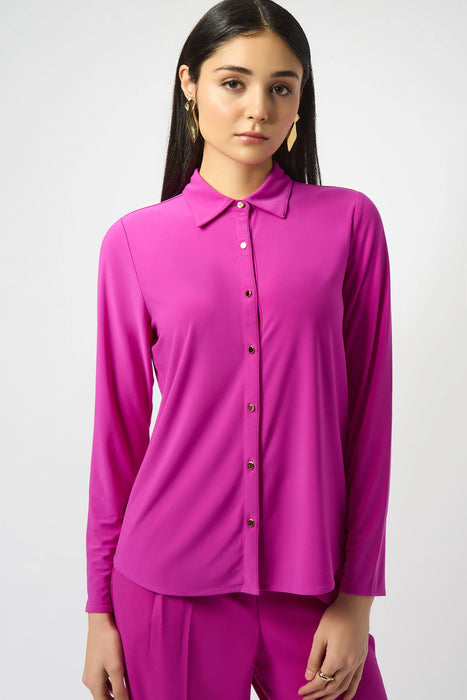Woman wearing a purple silky knit shirt with button front and long sleeves