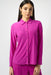 Woman wearing a purple silky knit shirt with button front and long sleeves