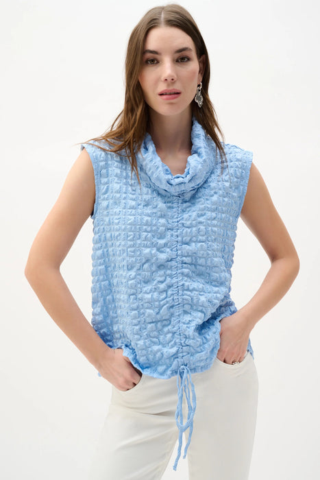 Woman wearing Joseph Ribkoff bubble jacquard straight top with cowl neck and drawstring hem styled for office chic, casual wear, and modern evening outfits.